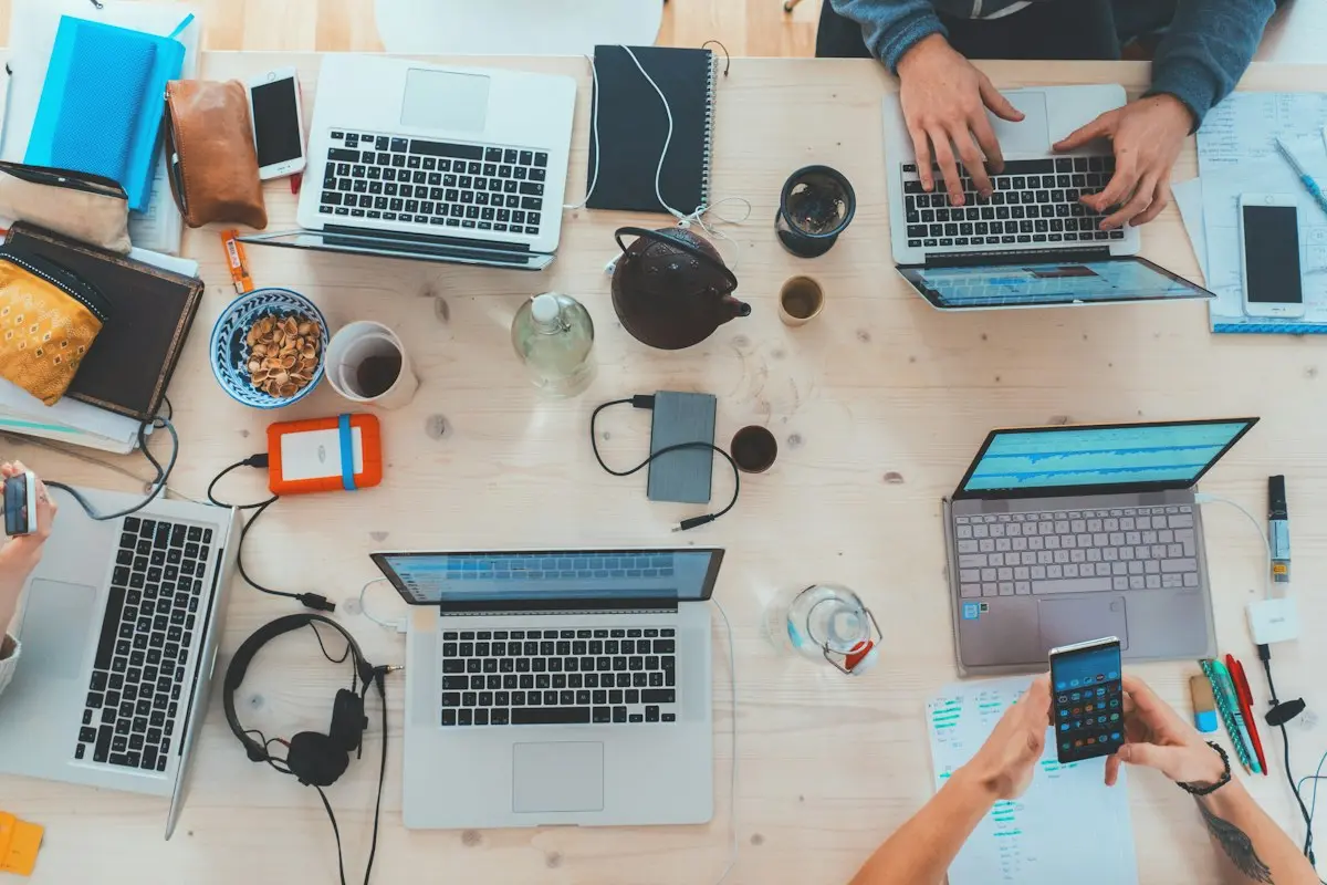 Team desk with laptops and notes